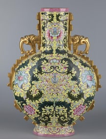 A Qianlong era enamel yellow ground passionflower elephant ear flat bottle