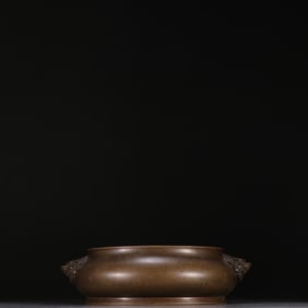 A Ming Dynasty Xuande copper tire double lion ear incense burner