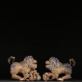 A pair  of Qing Dynasty silver-gilt burnt blue lion ornaments