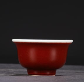 A Ming Dynasty Xuande Ji red blue and white cloud pattern press cup