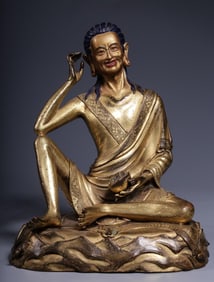 A seated statue of Venerable Milarepa in copper gilt from the Qing Dynasty