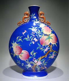 A Qing Qianlong model pastel gemstone blue ground nine peaches and five bats binaural moon vase