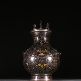 A copper wrong gold and silver amphora stove