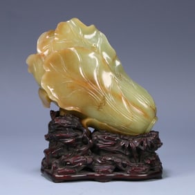 A piece of Qing Dynasty Hetian topaz carved cabbage ornament (with rosewood base)