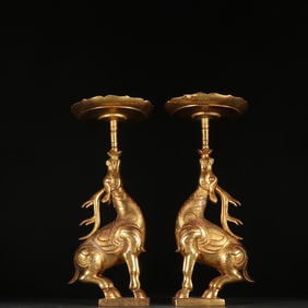 A pair  of Qing Dynasty copper-gilt deer-shaped candlesticks