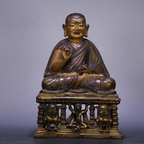 A 14th-century Tibetan Buddhist bronze gilt guru statue