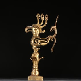 A copper-gilt phoenix ornament