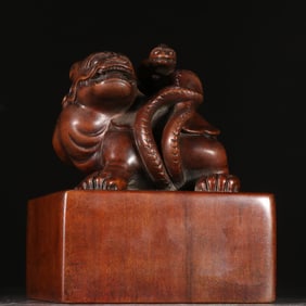 A Qing Dynasty sandalwood basalt button seal