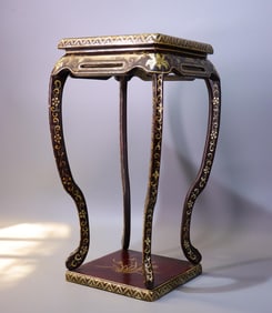 A Qing Dynasty wooden lacquered gold painted Qianlong year flower stand