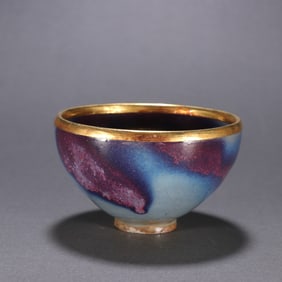 A gold cup wrapped in a jun kiln