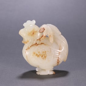 A carving of a Hetian jade chicken holding a wheat ear