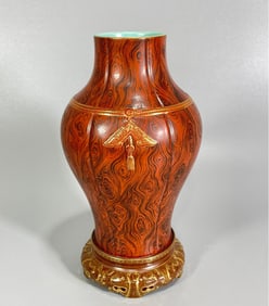 A Qianlong year carved gold-painted wood-grain glazed vase
