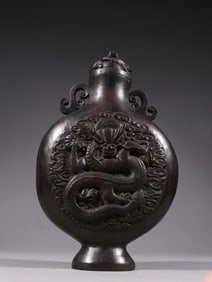 A Qing Dynasty agarwood carved dragon pattern ruyi ear appreciation bottle