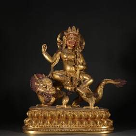 A statue of the God of Wealth in copper gilt and white