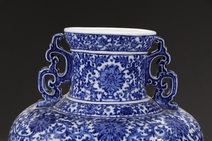 A Qing Qianlong blue and white entwined branch open window plum blossom amphora flat bottle