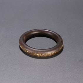 A Qing Dynasty agarwood gilded bracelet