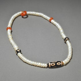 A piece of pearl with a Dzi necklace