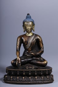A seated statue of the Buddha with a golden face in copper and silver mud in the Qing Dynasty