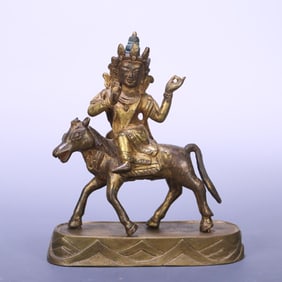 An 18th-century Tibetan bronze gilt statue of a horseback protector
