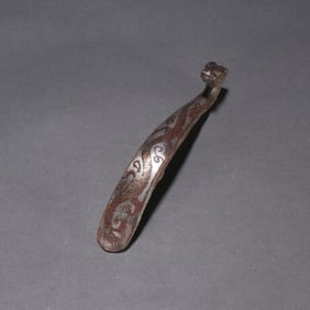 A piece of copper wrong gold and silver belt hook