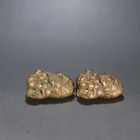 A pair of Qing Dynasty copper gilt lion ornaments