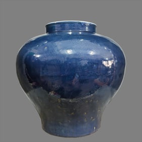 A large Ming Dynasty blue glaze carved dragon pattern jar