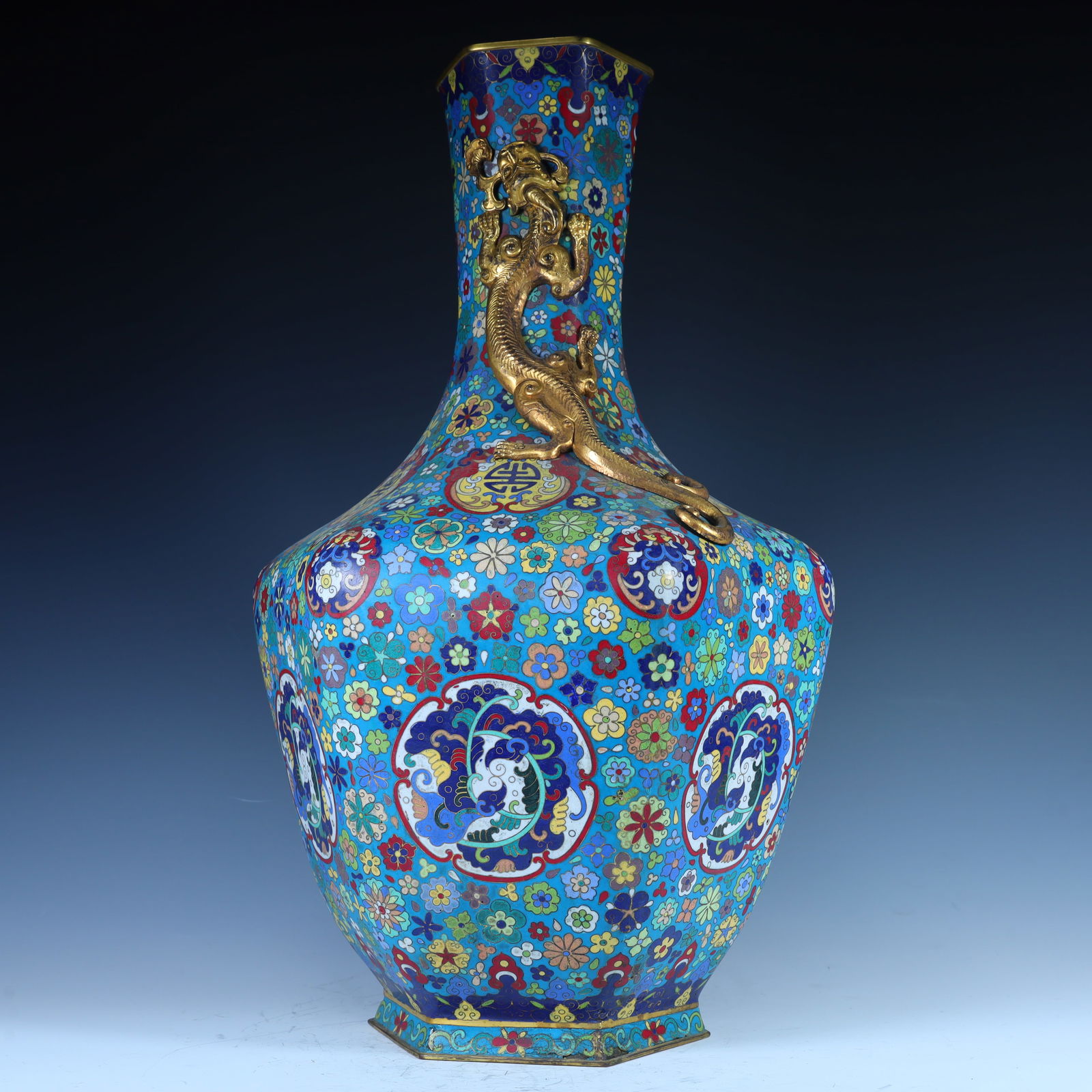 A Qing Dynasty cloisonné enamel carved dragon group pattern decorated with a hexagonal vase