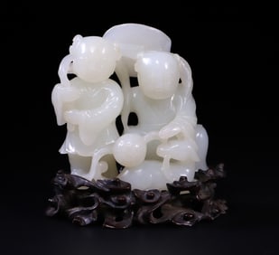 A Qing Dynasty white jade lotus boy