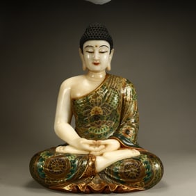 A Qing Dynasty white jade painted statue of Shakyamuni Buddha