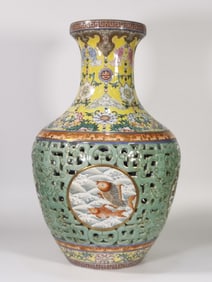 A Qing Dynasty Qianlong bean celadon gold-painted hollow carved fish set bottle