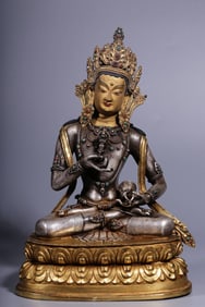 A seated statue of a Qing Dynasty copper-gilded gilt silver Vajrasa hammer