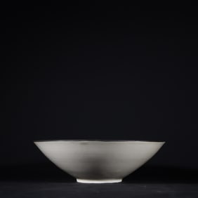 A Song Dynasty Ding kiln carved silver buckle bowl