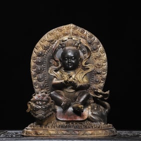 A statue of a Qing Dynasty bronze engraved boy riding a beast