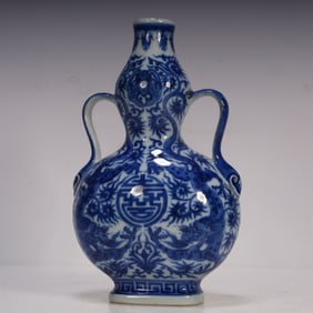 A Qing Dynasty blue and white double dragon holding the birthday ribbon gourd bottle