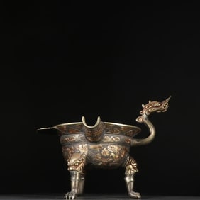 A Tang Dynasty copper-gilt gilt silver three-legged dragon head cup