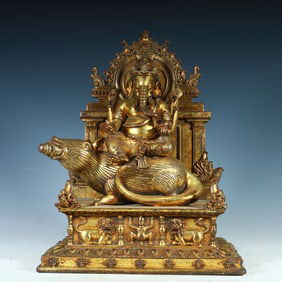 A Qing Dynasty copper gilt yellow god of wealth