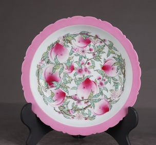 A Qing Dynasty Yongzheng carmine pastel eight peach blossom mouth plate