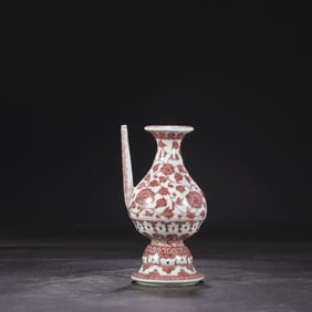 A Ming Dynasty Yongle glazed red entwined flower pattern military held