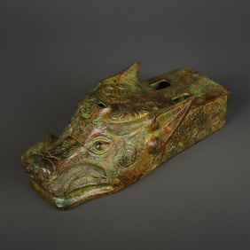 A Western Zhou bronze beast head horse-drawn cart accessory