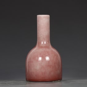 A Qing Dynasty Kangxi cowpea red rattle statue