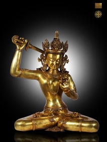 A seated statue of Manjushri Bodhisattva holding a sword in a bronze tire gilt in the Ming Dynasty