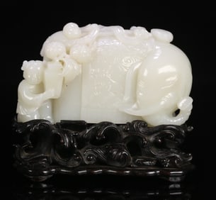 A Qing Dynasty rosewood and Tian jade "Boy Drama" ornament