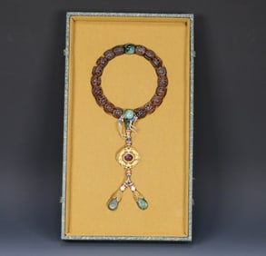 A Qing Dynasty court old amber group longevity pattern eighteen sons held