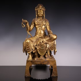 A bronze and gold gilt statue of Guanyin