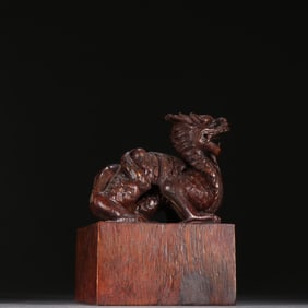 A Qing Dynasty agarwood dragon button overprint