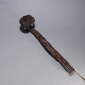 A Qing Dynasty small-leaved rosewood ruyi handle
