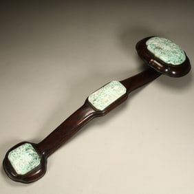A Qing Dynasty mahogany inlaid jade ruyi