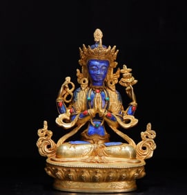 A piece of copper gilt inlaid with lapis lazuli four-armed Guanyin