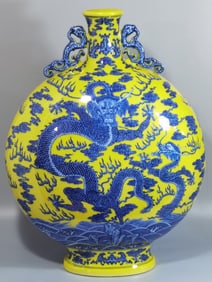 A Qing Dynasty Qianlong blue and white with yellow glaze Canglong godson holding the moon flat