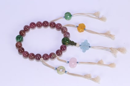 A Qing Dynasty court pink tourmaline with Duobao eighteen seeds in hand